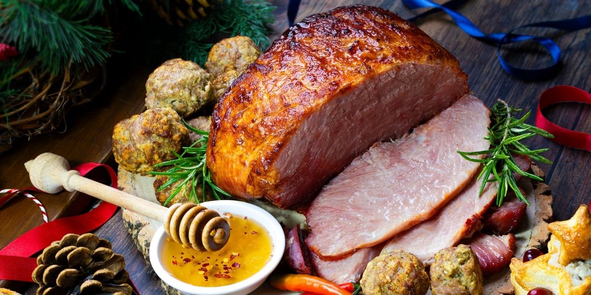 Gammon Joint Glazed with Dalesman Hot Honey Flavoured Glaze next to a bowl of hot honey